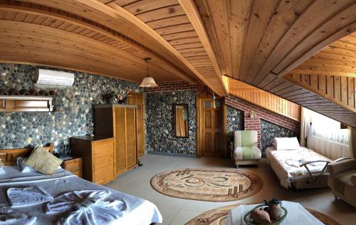 a room with two beds and a living room at Mertur Hotel in Çiftlikköy