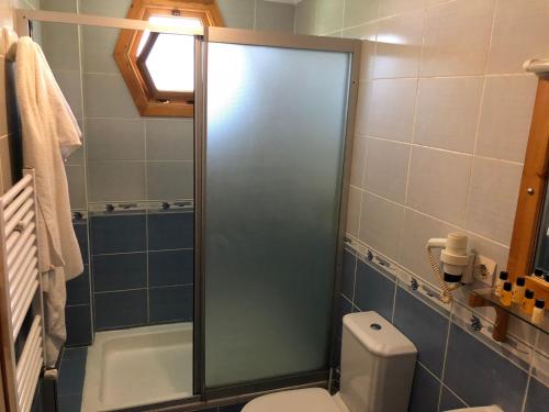 a bathroom with a shower with a toilet and a sink at Mertur Hotel in Çiftlikköy