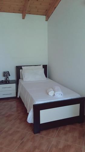 a bedroom with a bed with two towels on it at Imperial apartments in Ksamil