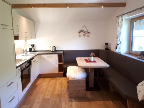 a small kitchen with a table in the corner at Hinterschwarzenau in Auffach