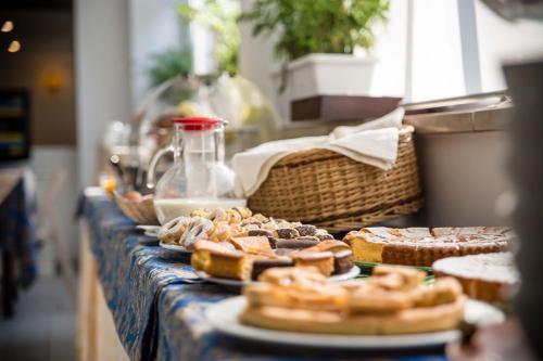 a buffet line with bread and pastries on a table at Wyndham Garden Conegliano in Conegliano