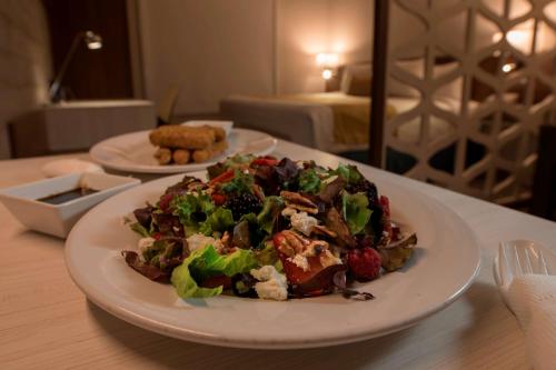 a salad on a plate on a table at Microtel Inn & Suites by Wyndham San Luis Potosi in San Luis Potosí