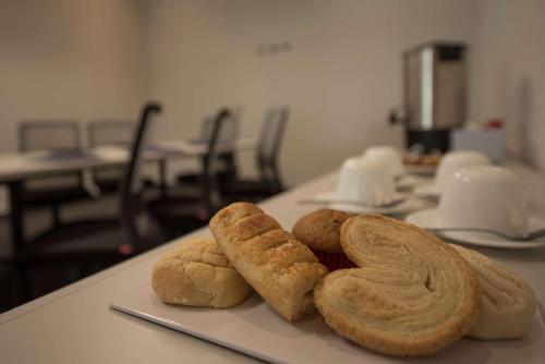 a bunch of breads sitting on a table at Microtel Inn & Suites by Wyndham San Luis Potosi in San Luis Potosí