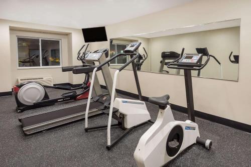 a gym with two tread machines and a mirror at Microtel Inn & Suites by Wyndham in Sandston