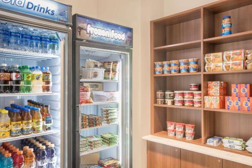 a refrigerator filled with lots of food and drinks at Microtel Inn & Suites by Wyndham Binghamton in Binghamton