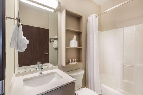 a bathroom with a sink and a toilet and a shower at Microtel Inn & Suites by Wyndham Perry in Perry