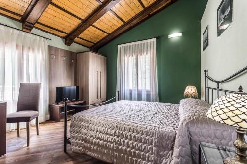 a bedroom with a bed and a green wall at Malatesta Antica Dimora in Longiano