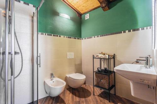 a bathroom with a toilet and a sink and a shower at Malatesta Antica Dimora in Longiano