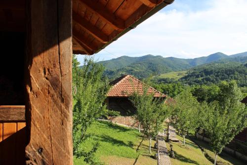 a view of a farm with trees and mountains at Ethno Village Bogut in Bogutovac