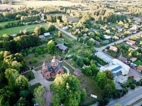 an aerial view of a small town with a church at Bliżej Natury in Białowieża
