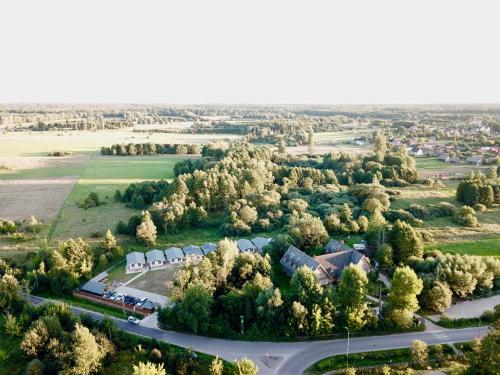 an aerial view of a village with trees and a road at Bliżej Natury in Białowieża