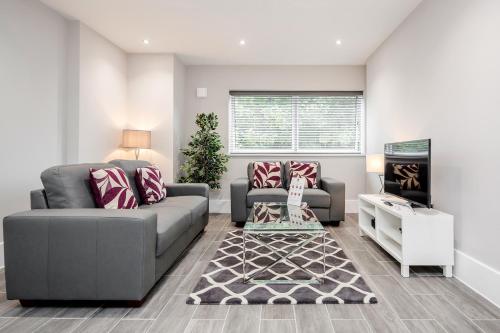 a living room with a couch and a fireplace at Roomspace Serviced Apartments - The Legacy in Brighton & Hove