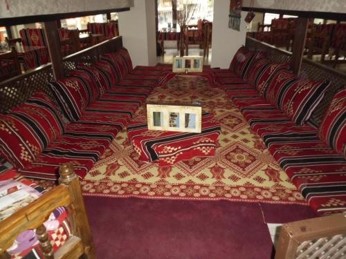 a row of chairs in a room with a rug at Hotel Kaya in Diyarbakır