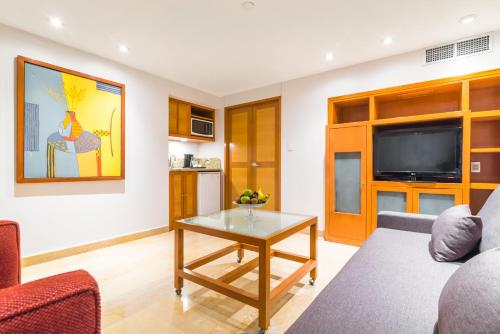 a living room with a couch and a table at Eurostars Zona Rosa Suites in Mexico City