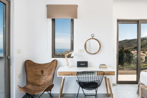 a room with a desk and a chair at NiMar Villas in Plaka