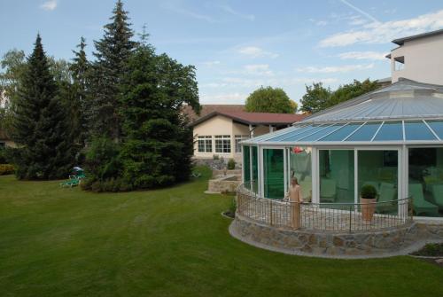 a house with a gazebo in a yard at Thermenhotel Quellenhof in Bad Füssing