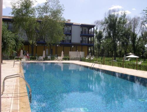 a large swimming pool in front of a building at Parador de Manzanares in Manzanares