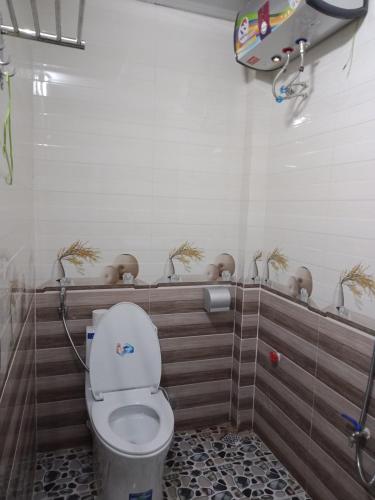a bathroom with a toilet in a stall at Ruby Hostel Hà Giang in Ha Giang