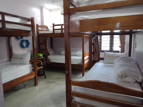 a room with four bunk beds in a dorm at Ruby Hostel Hà Giang in Ha Giang