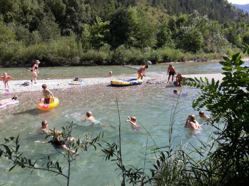a group of people swimming in a river at Les Acacias in Vercheny