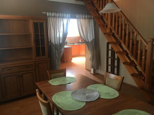 a dining room with a table with green plates on it at Penzion Žírovice in Františkovy Lázně