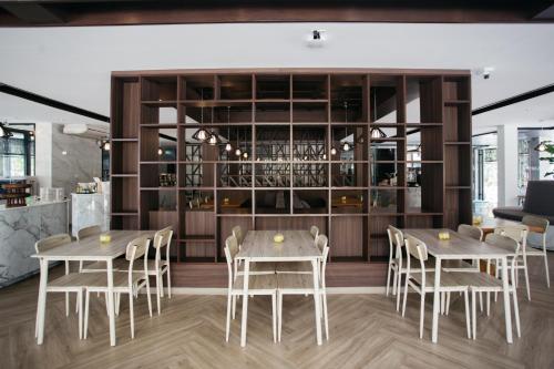 a restaurant with two tables and chairs and a bar at Diamond Park Inn Chiangrai & Resort in Chiang Rai