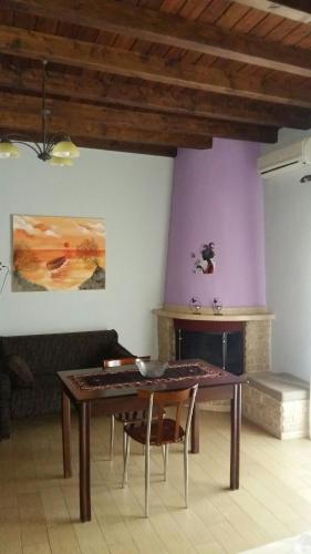 a dining room with a wooden table and chairs at Guesthouse Oneiro in Kato Loutraki