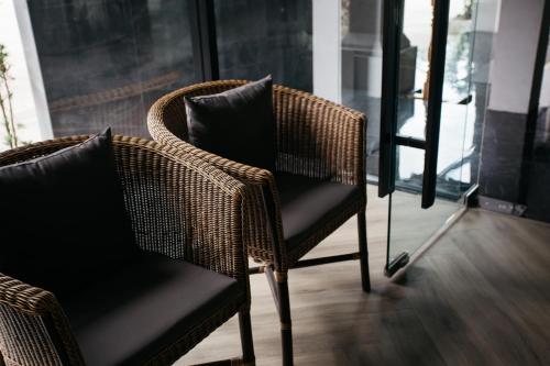 a wicker chair with a pillow in a room at Diamond Park Inn Chiangrai & Resort in Chiang Rai