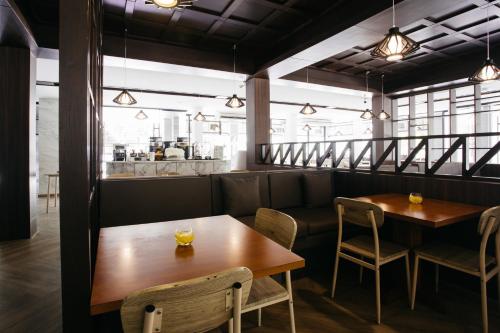 a restaurant with two tables and chairs and a counter at Diamond Park Inn Chiangrai & Resort in Chiang Rai
