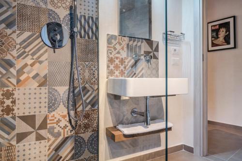 a bathroom with a sink and a shower at Paris Place in Scicli