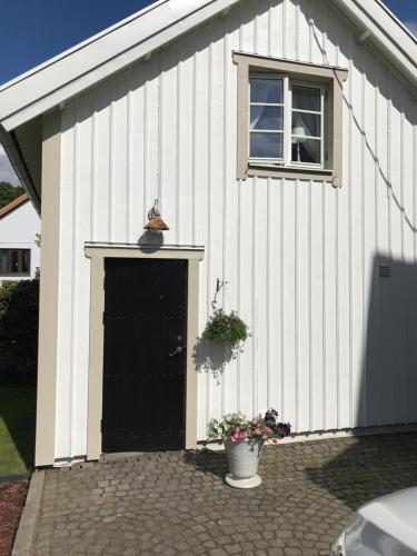 a white building with a black door and a window at Pia's House in Gothenburg
