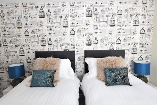 a bedroom with two beds and a wall with music at The Old Bank - Your Apartment in Bristol