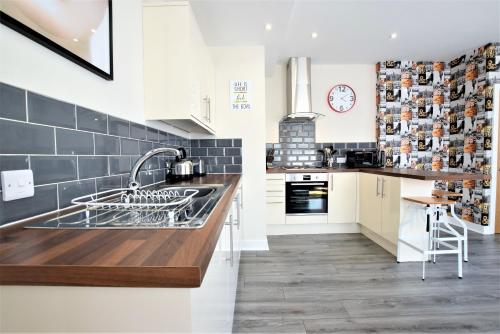 a kitchen with a sink and a counter at The Old Bank - Your Apartment in Bristol