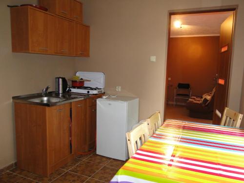 a kitchen with a sink and a table with a tablecloth at Sławska Poręba in Sława