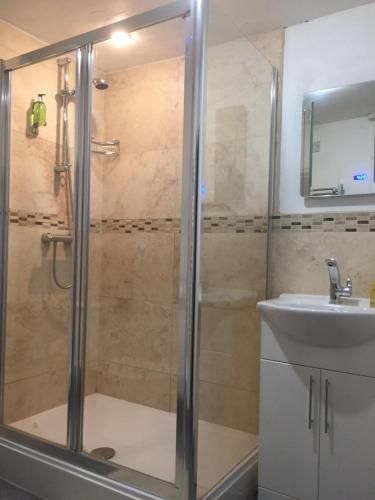 a bathroom with a shower and a sink at The Post House in Ibstock