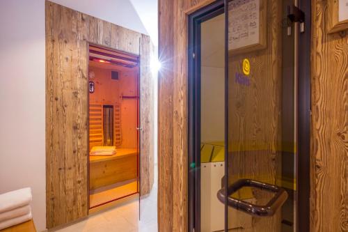a glass door leading to a shower in a room at Sporthotel Austria in Sankt Johann in Tirol