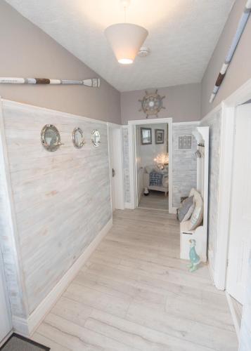 a hallway with a large wooden door in a house at Sefton Cottage in Deganwy