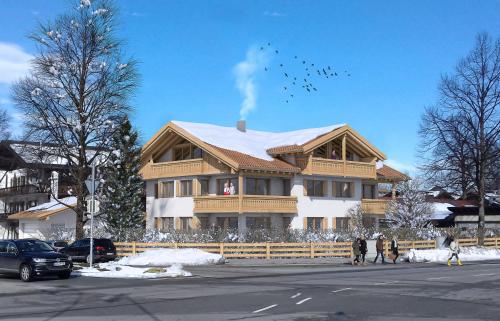 a large wooden house with a flock of birds flying at Ferienwohnungen "Zur Wally" in Garmisch-Partenkirchen