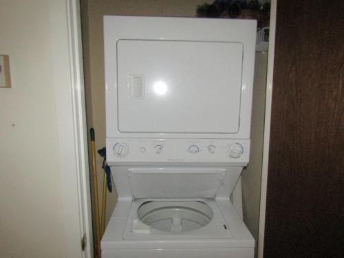a white toilet in a small bathroom with its door open at Briarcliff C11 Condo in Sugar Mountain