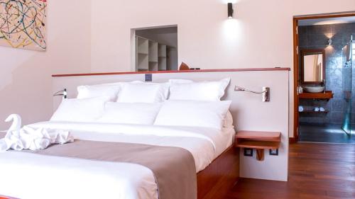 a bedroom with a large bed with white pillows at Villa La Ressource in Le François