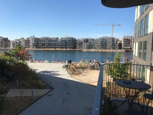 a view of a body of water with people on the beach at Home Stay Marmormolen (Marmorvej) in Copenhagen