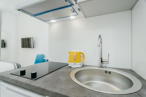 La salle de bains est pourvue d'un lavabo avec un objet jaune sur un comptoir. dans l'établissement SIA Downtown Apartments, à Zagreb