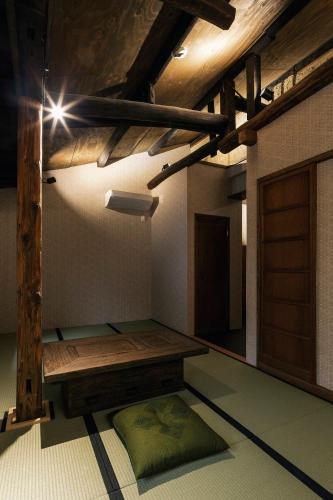 a room with a wooden bench and a door at Hazuki Kyoto in Kyoto