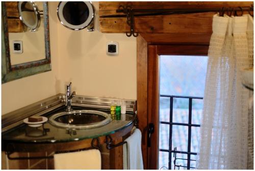 a bathroom with a sink and a window at El Rincón de Rascafría in Rascafría