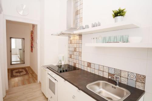 a kitchen with a sink and a counter top at Lillybeth City Center Apartments in Budapest