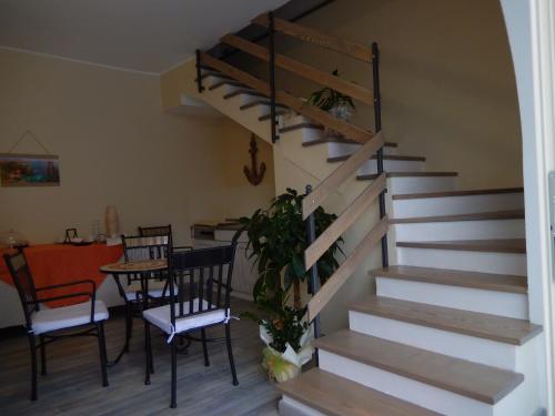 a staircase in a room with chairs and a table at B&B Magna Graecia in Scalea