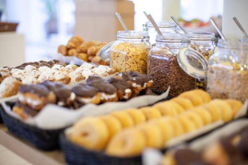 a display of different types of donuts and jars of food at Grupotel Santa Eulària & Spa - Adults Only in Santa Eularia des Riu