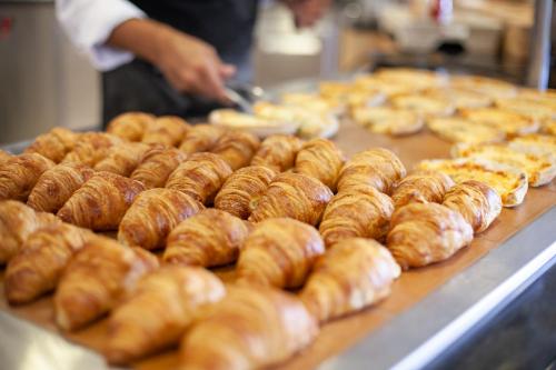 a bunch of donuts on a counter in a bakery at Grupotel Santa Eulària & Spa - Adults Only in Santa Eularia des Riu