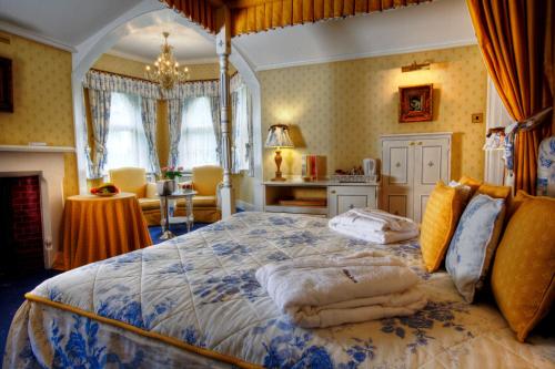 a bedroom with a bed with towels on it at Best Western Abbots Barton Hotel in Canterbury
