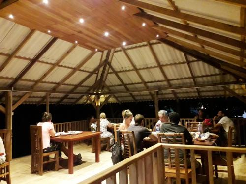 a group of people sitting at tables in a tent at Sigiriya Paradise Inn in Sigiriya